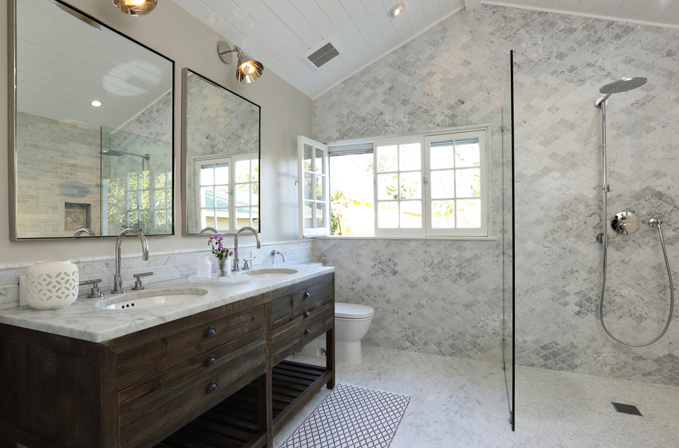 Inspiration for a traditional grey and white bathroom in Los Angeles with dark wood cabinets, a freestanding bath, a built-in shower, a two-piece toilet, a submerged sink and flat-panel cabinets.