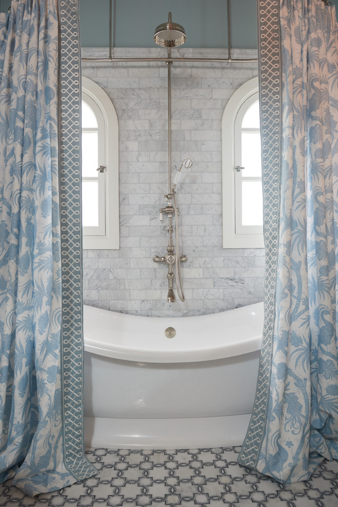 This is an example of a large traditional ensuite bathroom in Los Angeles with freestanding cabinets, white cabinets, a freestanding bath, grey tiles, stone tiles, blue walls, mosaic tile flooring, a submerged sink, marble worktops and a shower/bath combination.