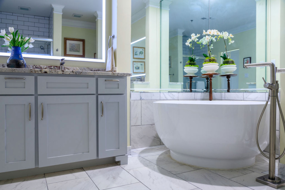 Bathroom - mid-sized traditional master white tile and marble tile marble floor, white floor and double-sink bathroom idea in Atlanta with shaker cabinets, gray cabinets, a one-piece toilet, yellow walls, an undermount sink, granite countertops, beige countertops and a freestanding vanity