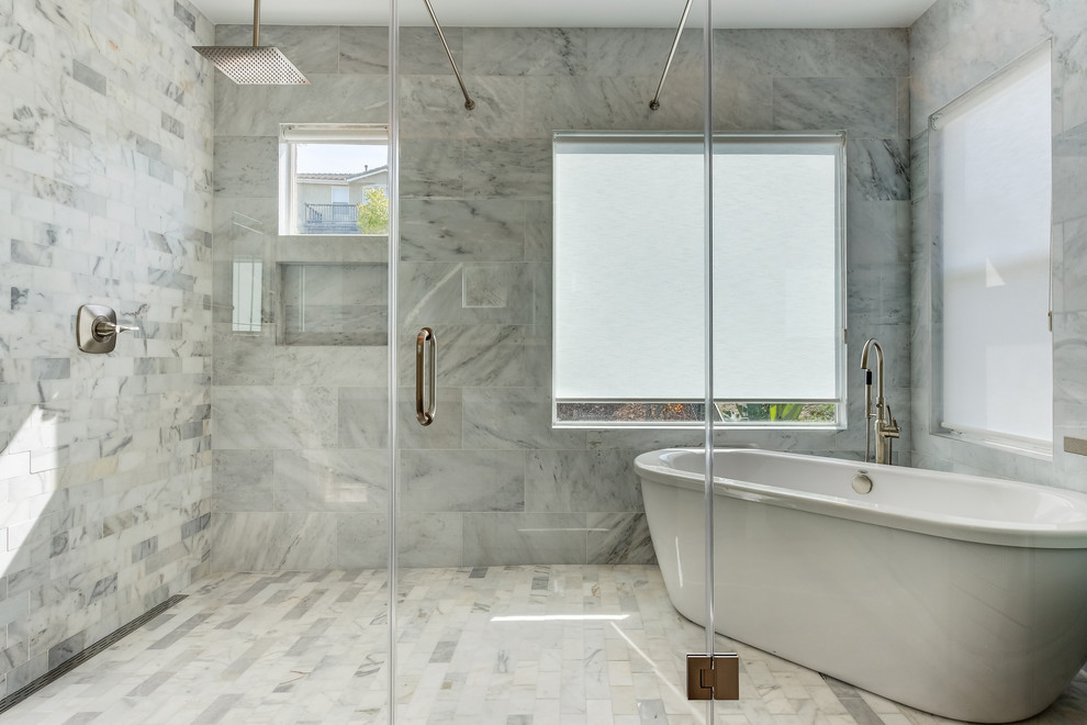 Inspiration for a medium sized contemporary ensuite bathroom with grey cabinets, a freestanding bath, a shower/bath combination, white tiles, porcelain tiles, white walls, porcelain flooring, a submerged sink, engineered stone worktops, white floors, a hinged door, white worktops and beaded cabinets.