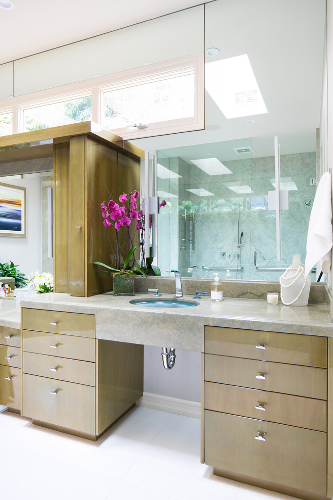 Large contemporary ensuite bathroom in San Diego with flat-panel cabinets, medium wood cabinets, a submerged bath, a two-piece toilet, multi-coloured tiles, beige walls, a submerged sink, white floors, a hinged door, multi-coloured worktops and an alcove shower.