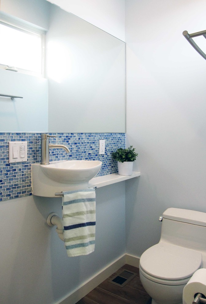 Inspiration for a small contemporary family bathroom in San Diego with a wall-mounted sink, wooden worktops, an alcove shower, a one-piece toilet, blue tiles, glass tiles, blue walls and porcelain flooring.