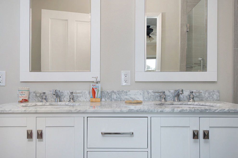 Inspiration for a small coastal master gray tile and porcelain tile porcelain tile and gray floor bathroom remodel in San Diego with recessed-panel cabinets, white cabinets, a two-piece toilet, gray walls, an undermount sink and quartzite countertops