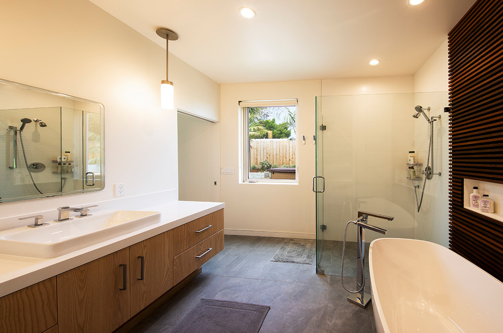 Mid-sized minimalist master white tile and ceramic tile slate floor and gray floor bathroom photo in Santa Barbara with flat-panel cabinets, light wood cabinets, a one-piece toilet, white walls, a vessel sink, quartzite countertops, a hinged shower door and white countertops