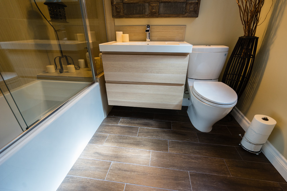 Mid-sized master beige tile and porcelain tile medium tone wood floor, brown floor and single-sink bathroom photo in San Diego with flat-panel cabinets, light wood cabinets, a two-piece toilet, beige walls, a drop-in sink, quartzite countertops, white countertops and a floating vanity