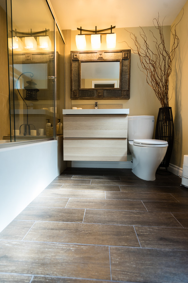 Bathroom - mid-sized zen master beige tile and porcelain tile medium tone wood floor and single-sink bathroom idea in San Diego with flat-panel cabinets, light wood cabinets, a two-piece toilet, beige walls, a drop-in sink, quartzite countertops, white countertops and a floating vanity