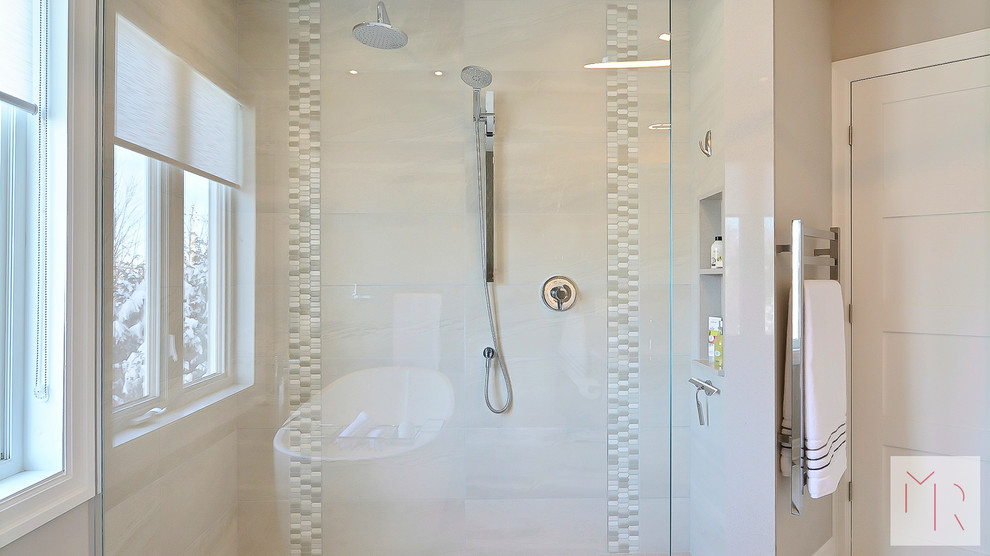 Photo of a medium sized modern ensuite bathroom in Montreal with flat-panel cabinets, grey cabinets, a freestanding bath, a double shower, a one-piece toilet, grey tiles, ceramic tiles, grey walls, ceramic flooring, a submerged sink, engineered stone worktops, grey floors and an open shower.