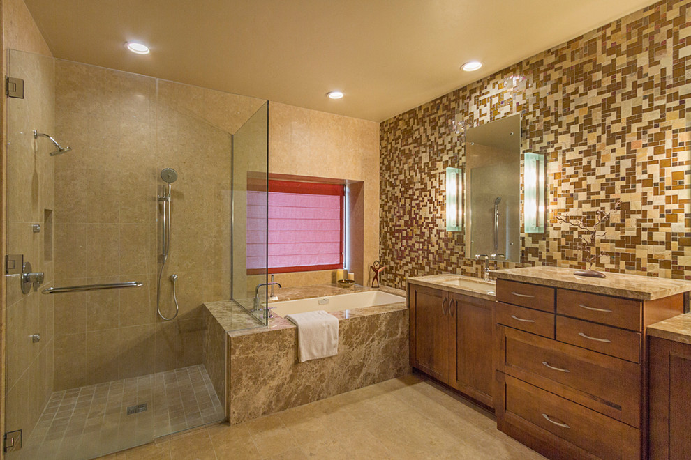 Inspiration for a mid-sized modern master beige tile and stone tile limestone floor corner shower remodel in Phoenix with an undermount sink, recessed-panel cabinets, medium tone wood cabinets, marble countertops, an undermount tub, a two-piece toilet and beige walls