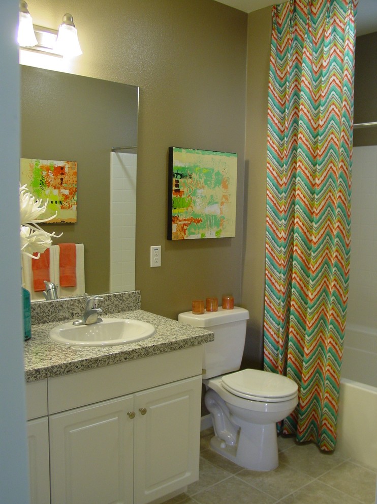 Example of a mid-sized transitional 3/4 ceramic tile bathroom design in Los Angeles with raised-panel cabinets, white cabinets, a two-piece toilet, beige walls and granite countertops