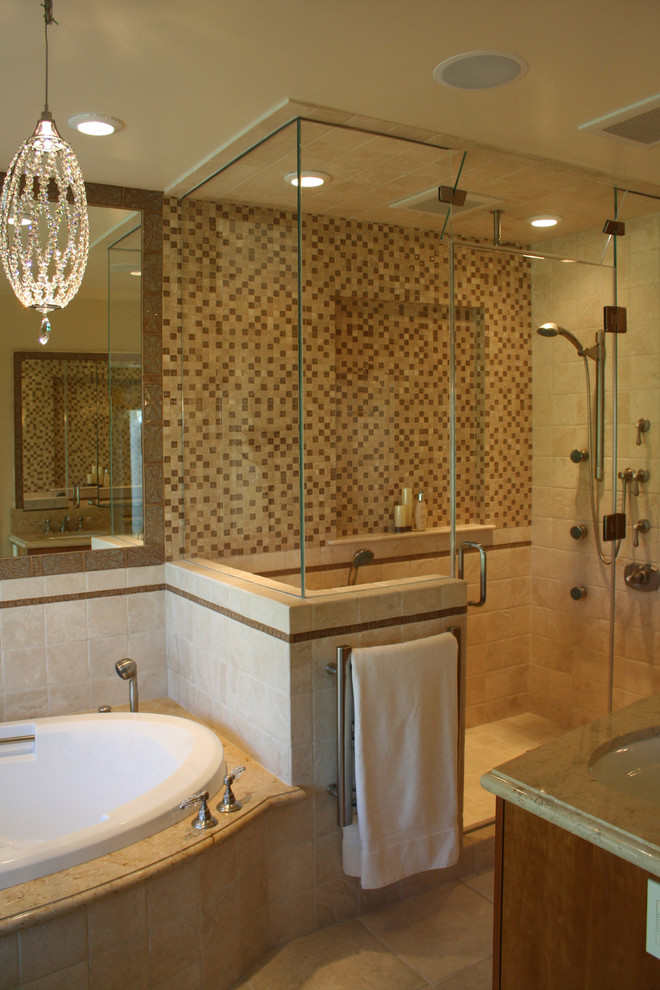 Klassisk inredning av ett mellanstort en-suite badrum, med skåp i mellenmörkt trä, flerfärgad kakel, ett undermonterad handfat, släta luckor, ett undermonterat badkar, en dusch i en alkov, stenkakel och kalkstensgolv