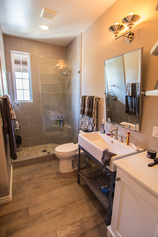 Mid-sized transitional 3/4 gray tile and porcelain tile light wood floor doorless shower photo in Orange County with a console sink, raised-panel cabinets, white cabinets, wood countertops, a one-piece toilet and beige walls