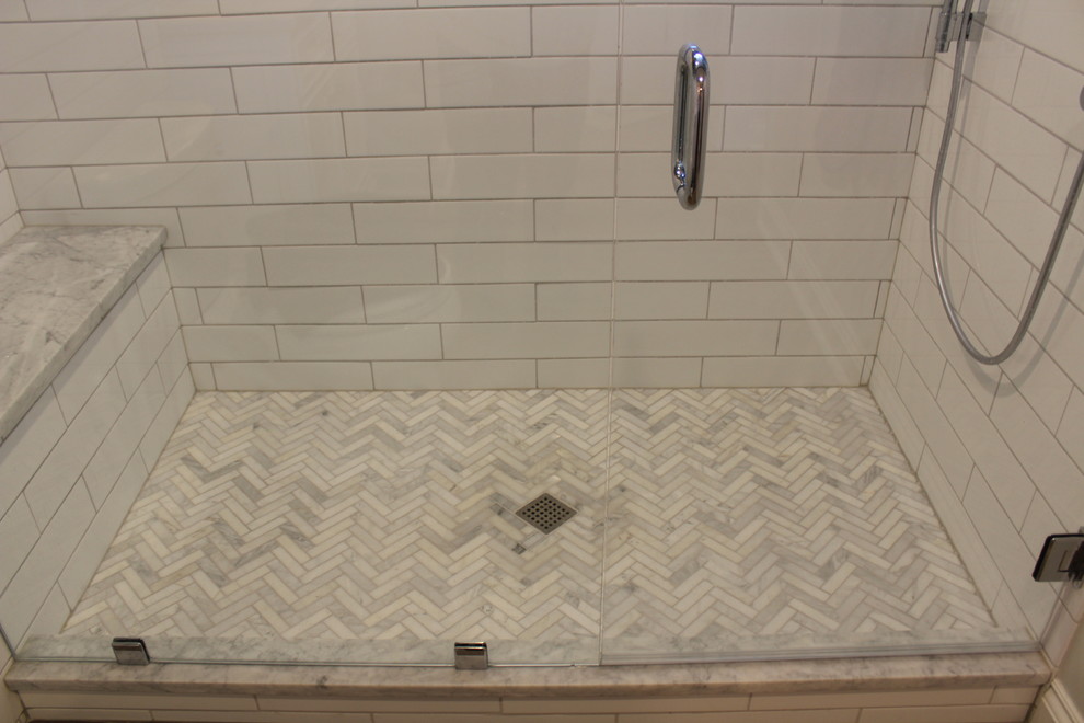 Mid-sized 3/4 white tile and subway tile vinyl floor alcove shower photo in St Louis with furniture-like cabinets, white cabinets, gray walls, an undermount sink, marble countertops, a hinged shower door and white countertops