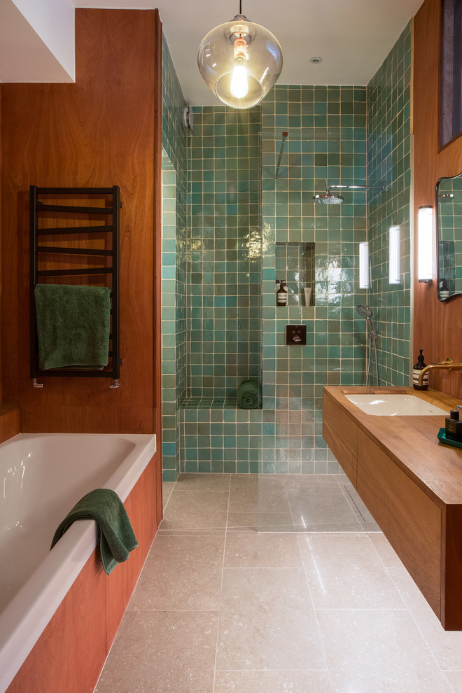 На фото: большая главная ванная комната в стиле фьюжн с плоскими фасадами, темными деревянными фасадами, накладной ванной, открытым душем, унитазом-моноблоком, зеленой плиткой, керамической плиткой, зелеными стенами, полом из известняка, накладной раковиной, столешницей из дерева, зеленым полом и открытым душем