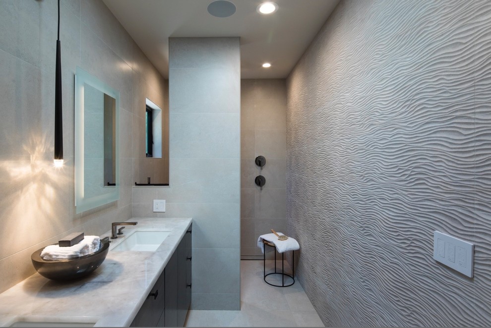 Mid-sized minimalist master gray tile and ceramic tile ceramic tile and gray floor bathroom photo in San Francisco with flat-panel cabinets, medium tone wood cabinets, a one-piece toilet, gray walls, an undermount sink, quartzite countertops and beige countertops