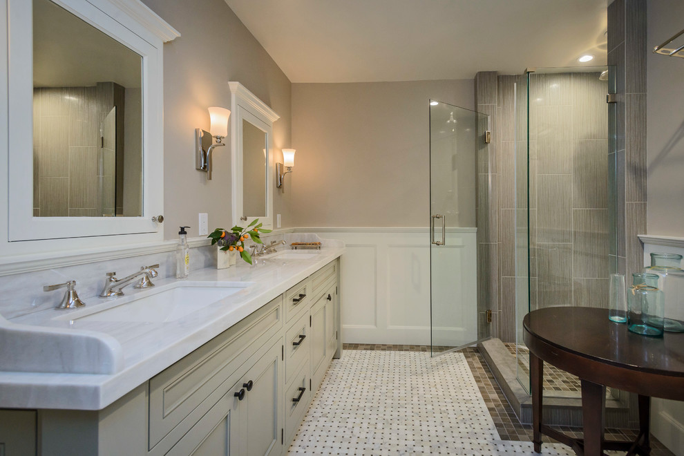 This is an example of a medium sized classic ensuite bathroom in San Francisco with recessed-panel cabinets, grey cabinets, an alcove shower, a one-piece toilet, grey tiles, porcelain tiles, grey walls, mosaic tile flooring, a submerged sink, marble worktops, white floors and a hinged door.