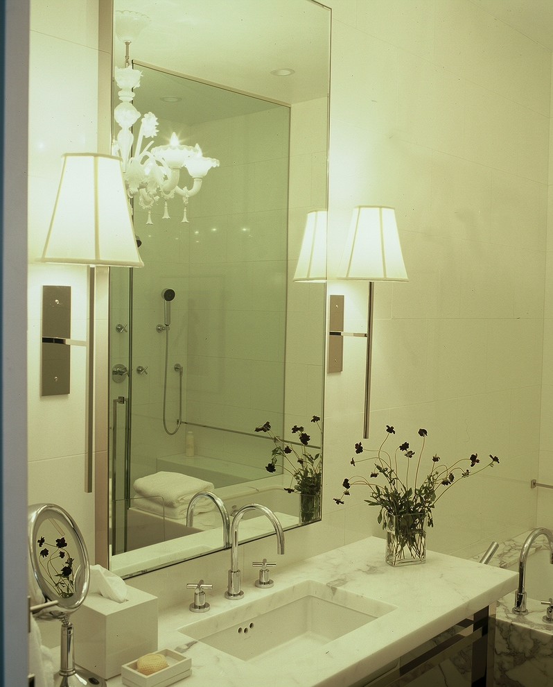 Inspiration for a contemporary white tile bathroom remodel in Other with an undermount sink and marble countertops