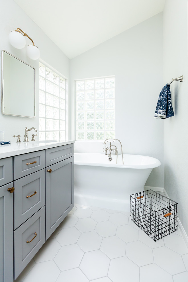 Bathroom - mid-sized country master white tile and ceramic tile ceramic tile and white floor bathroom idea in Denver with shaker cabinets, gray cabinets, a one-piece toilet, white walls, an undermount sink, quartzite countertops, a hinged shower door and white countertops
