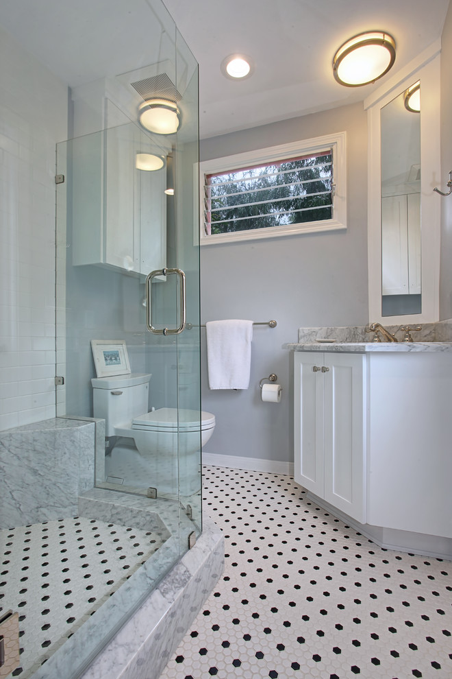 Example of a mid-sized arts and crafts 3/4 gray tile mosaic tile floor double shower design in Orange County with shaker cabinets, white cabinets, a drop-in sink and yellow walls