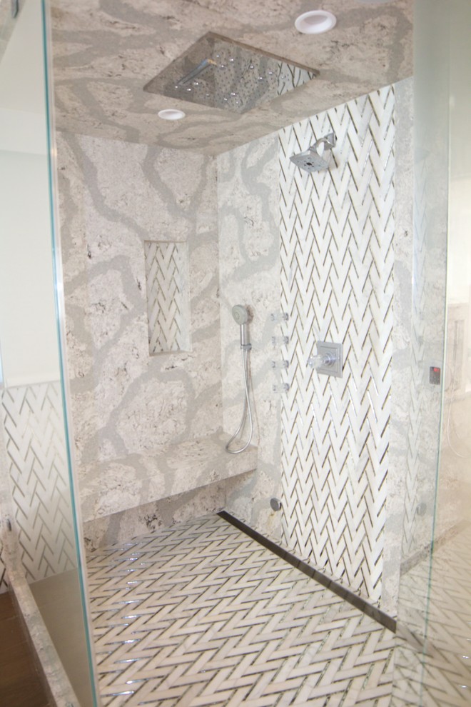 Large modern ensuite bathroom in Orange County with flat-panel cabinets, white cabinets, a freestanding bath, a corner shower, multi-coloured tiles, white tiles, marble tiles, white walls, light hardwood flooring, a submerged sink, quartz worktops, beige floors, a hinged door and multi-coloured worktops.