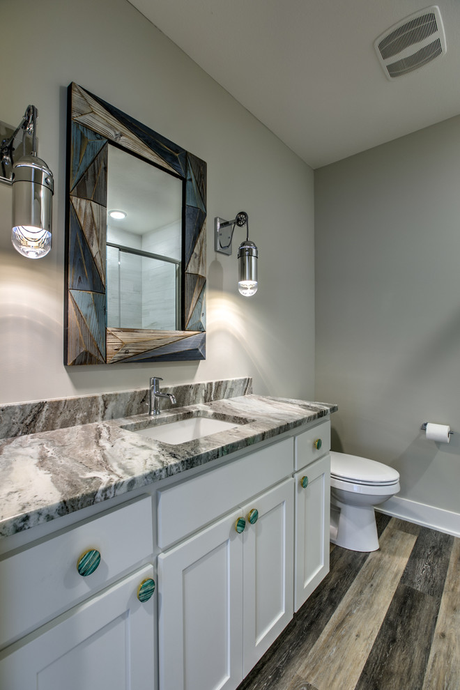 Design ideas for a nautical shower room bathroom in Omaha with shaker cabinets, white cabinets, an alcove shower, a two-piece toilet, a submerged sink, engineered stone worktops and a hinged door.