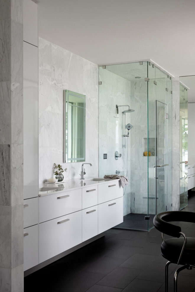 Idee per una stanza da bagno moderna con ante lisce, ante bianche, doccia ad angolo, piastrelle grigie, lavabo sottopiano, pavimento nero e top bianco