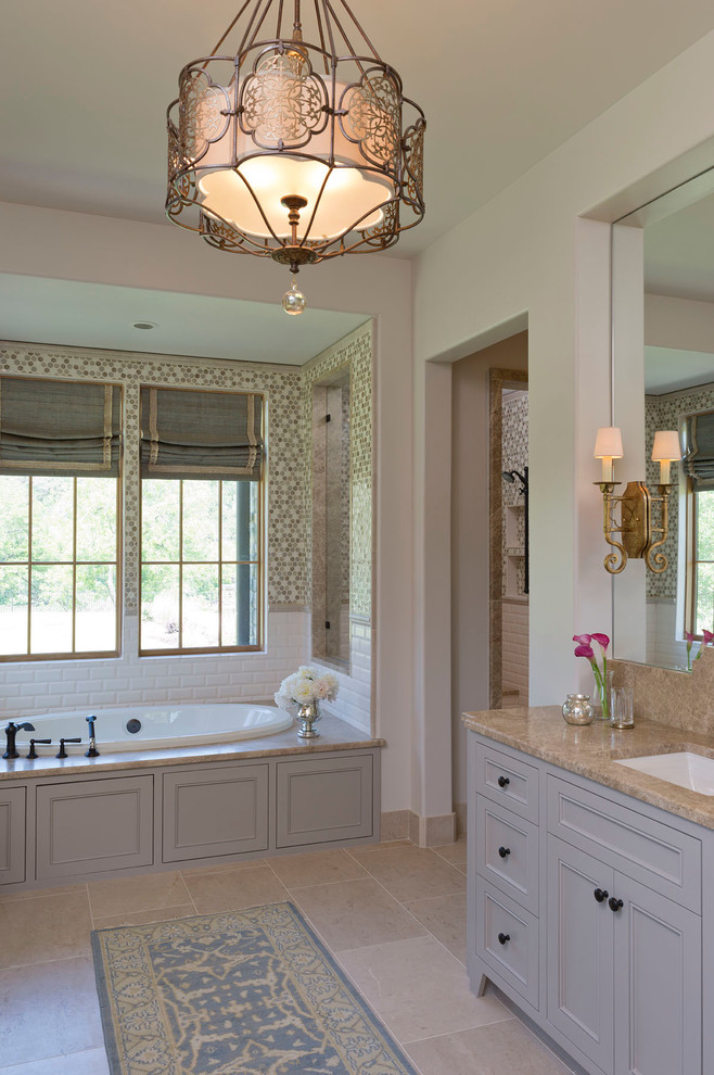 This is an example of a classic bathroom in Austin with a submerged sink, white tiles and beige walls.