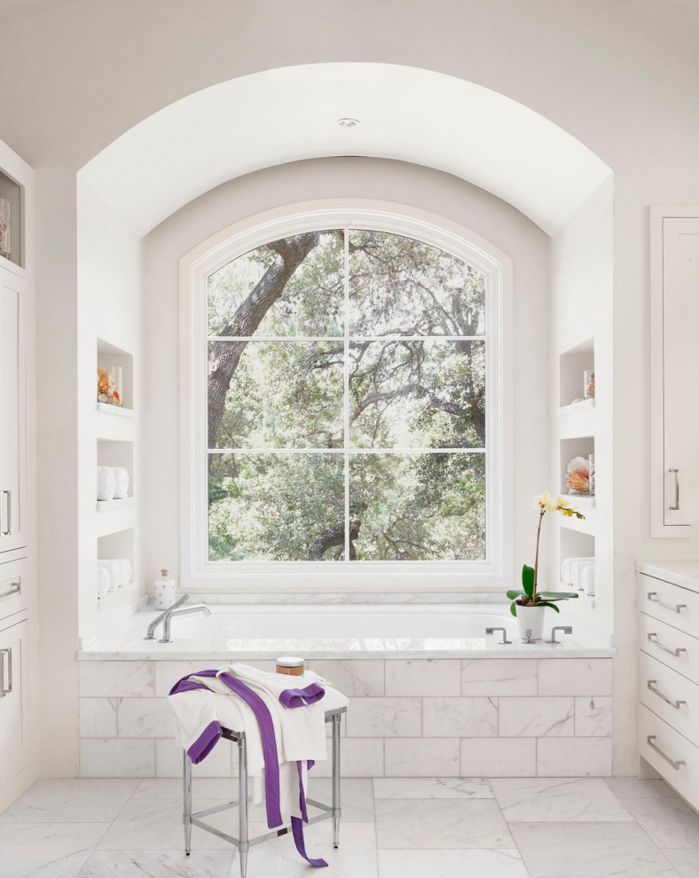 Inspiration for a medium sized mediterranean ensuite bathroom in Austin with white cabinets, white tiles, white walls, white floors, white worktops, shaker cabinets, a submerged bath and a built in vanity unit.