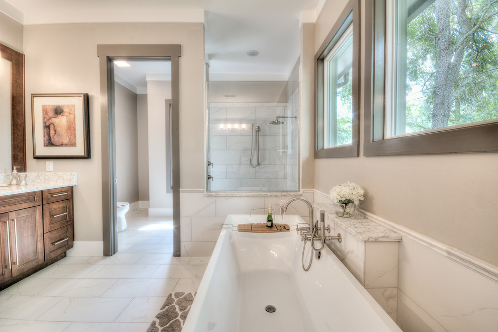 Inspiration for a large transitional master white tile and ceramic tile ceramic tile bathroom remodel in Orlando with an integrated sink, recessed-panel cabinets, medium tone wood cabinets, quartz countertops, a one-piece toilet and gray walls