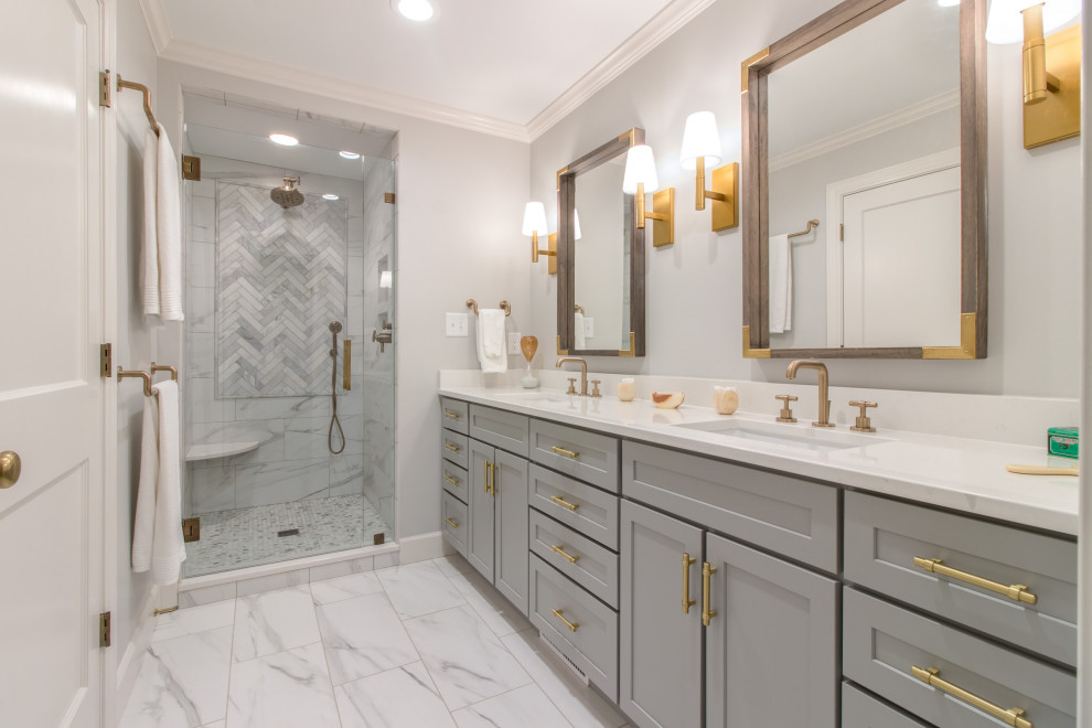 This is an example of a traditional shower room bathroom in Raleigh with shaker cabinets, grey cabinets, an alcove shower, white tiles, grey walls, a submerged sink, white floors, a hinged door, white worktops, a wall niche, a shower bench, double sinks and a built in vanity unit.
