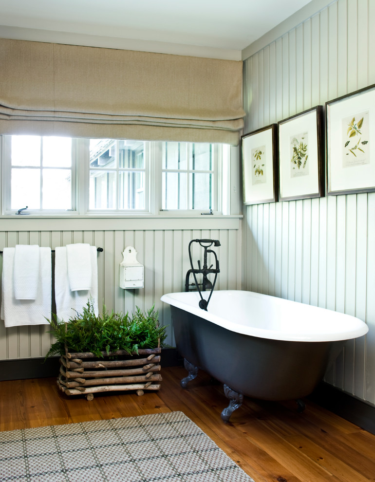 Ispirazione per una stanza da bagno padronale country con vasca con piedi a zampa di leone, pareti grigie, parquet scuro e pavimento marrone