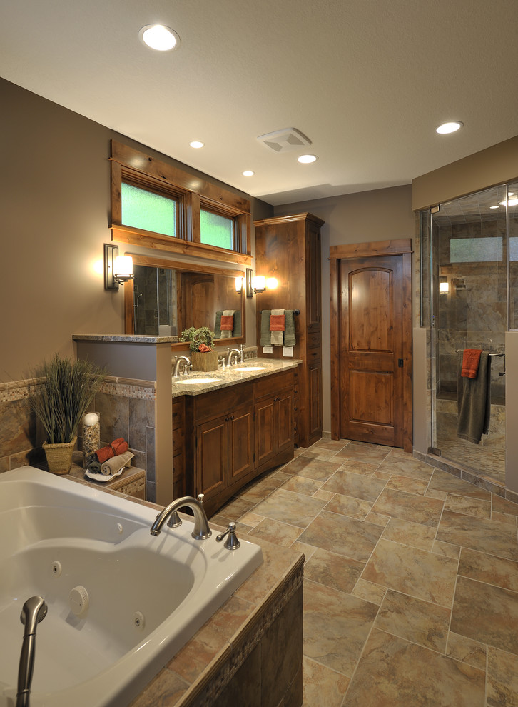 Bathroom - traditional brown tile brown floor bathroom idea in Minneapolis with recessed-panel cabinets and medium tone wood cabinets