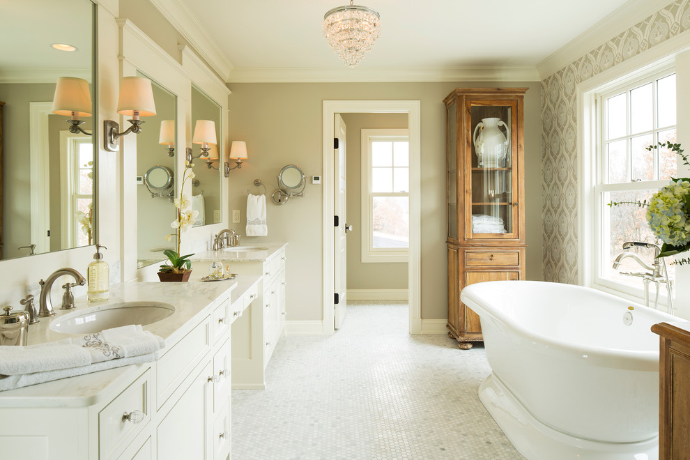 Farmhouse freestanding bathtub photo in Minneapolis with an undermount sink and marble countertops