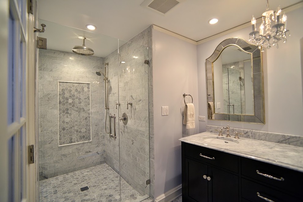 Mid-sized elegant master white tile and stone slab pebble tile floor and gray floor double shower photo in Chicago with an integrated sink, furniture-like cabinets, dark wood cabinets, marble countertops, a one-piece toilet, white walls and a hinged shower door
