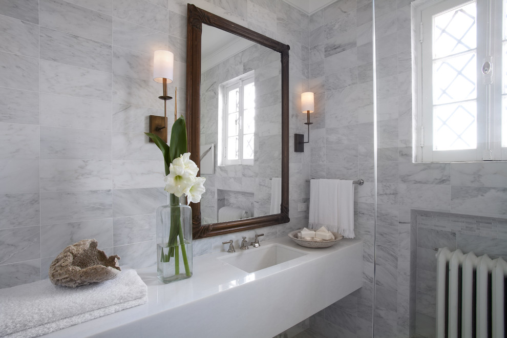 Пример оригинального дизайна: маленькая ванная комната в стиле неоклассика (современная классика) с монолитной раковиной, серой плиткой, плоскими фасадами, белыми фасадами, мраморной столешницей и мраморной плиткой для на участке и в саду
