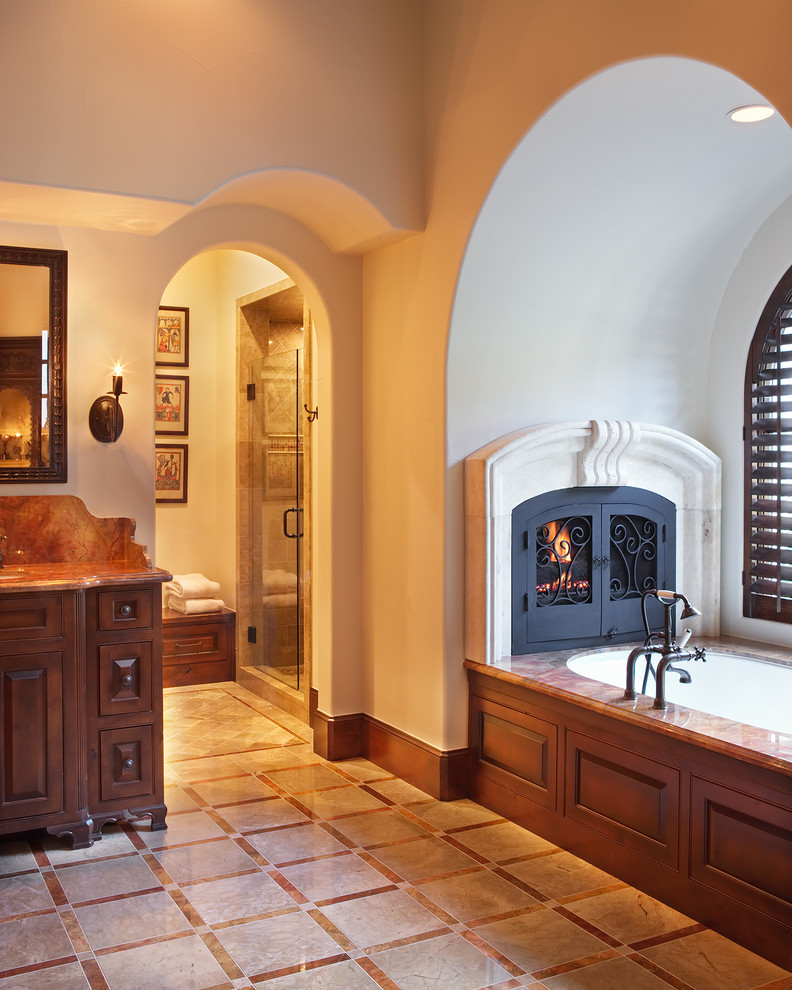 Inspiration for a mediterranean bathroom remodel in Austin with an undermount tub