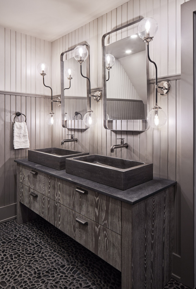 Mountain style pebble tile floor, black floor, double-sink and wainscoting bathroom photo in Ottawa with flat-panel cabinets, gray cabinets, gray walls, a vessel sink, gray countertops and a built-in vanity