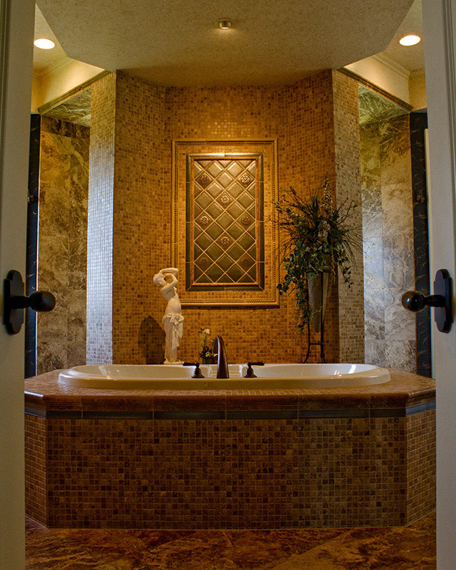 Large tuscan master brown tile and mosaic tile travertine floor bathroom photo in Charlotte with beige walls