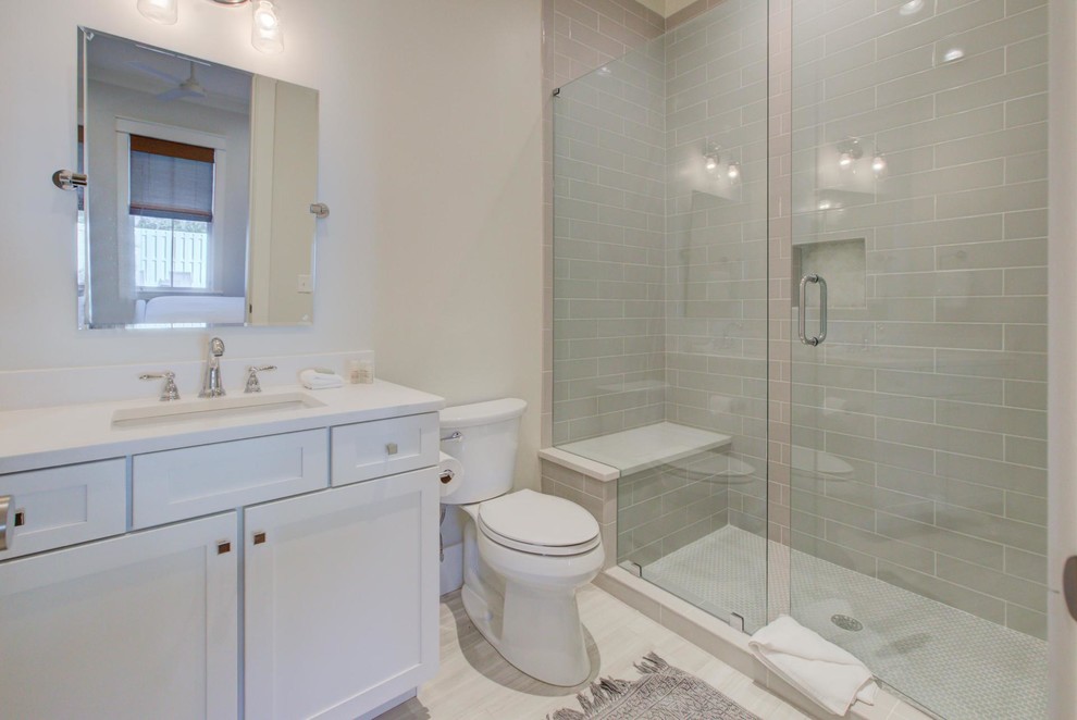Small arts and crafts 3/4 beige tile and porcelain tile porcelain tile and white floor bathroom photo in Miami with shaker cabinets, white cabinets, white walls, an undermount sink, quartzite countertops and white countertops