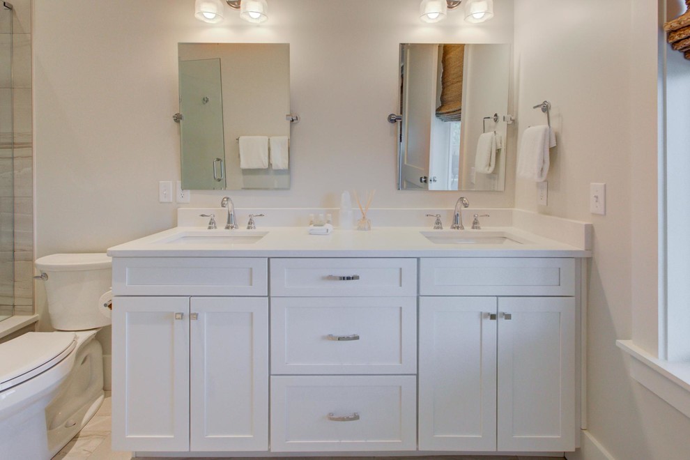 Cette photo montre une petite salle d'eau craftsman avec un placard à porte shaker, des portes de placard blanches, une douche ouverte, un carrelage beige, des carreaux de porcelaine, un mur blanc, un sol en carrelage de porcelaine, un lavabo encastré, un plan de toilette en quartz, un sol blanc et un plan de toilette blanc.