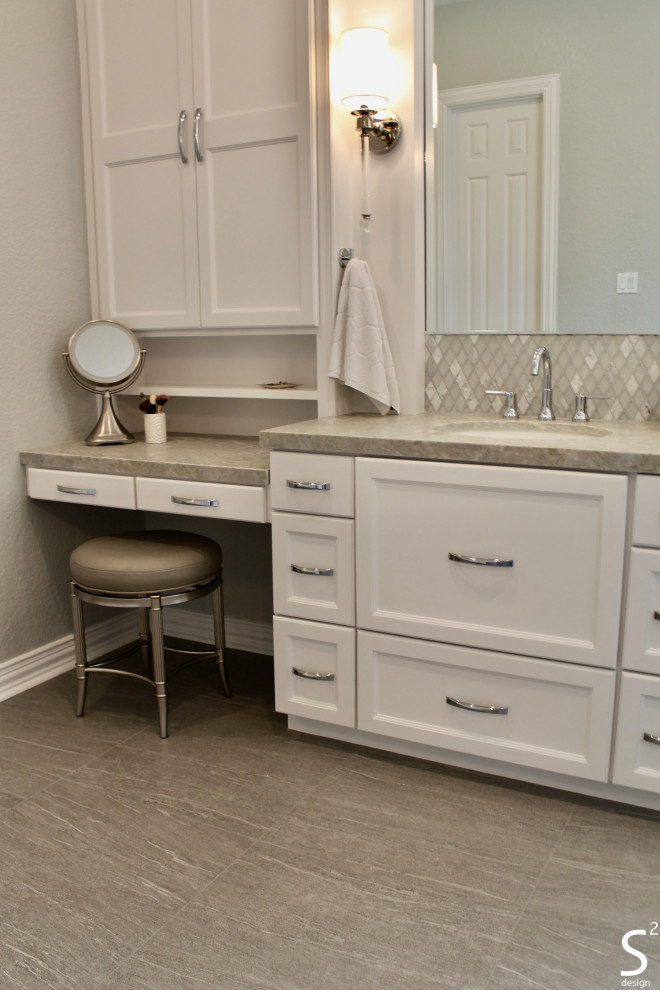 Example of a large transitional master white tile and porcelain tile porcelain tile, gray floor and double-sink bathroom design in Houston with recessed-panel cabinets, white cabinets, a one-piece toilet, gray walls, an undermount sink, quartzite countertops, a hinged shower door, gray countertops and a built-in vanity