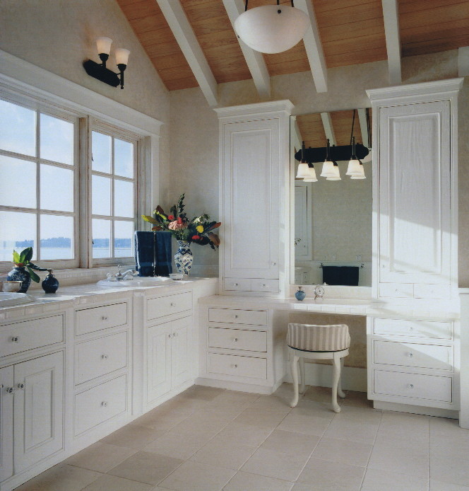 This is an example of a medium sized beach style ensuite bathroom in Seattle with raised-panel cabinets, white cabinets, white tiles, porcelain tiles, white walls, marble flooring, a built-in sink, tiled worktops and a built-in bath.