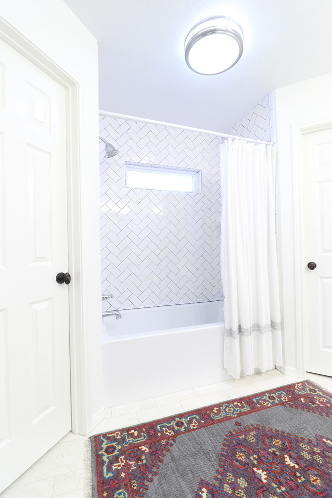 Idée de décoration pour une salle de bain principale tradition de taille moyenne avec un placard à porte shaker, des portes de placard grises, un carrelage blanc, un carrelage métro, un mur blanc, un sol en calcaire, un lavabo encastré, un plan de toilette en marbre et un sol blanc.