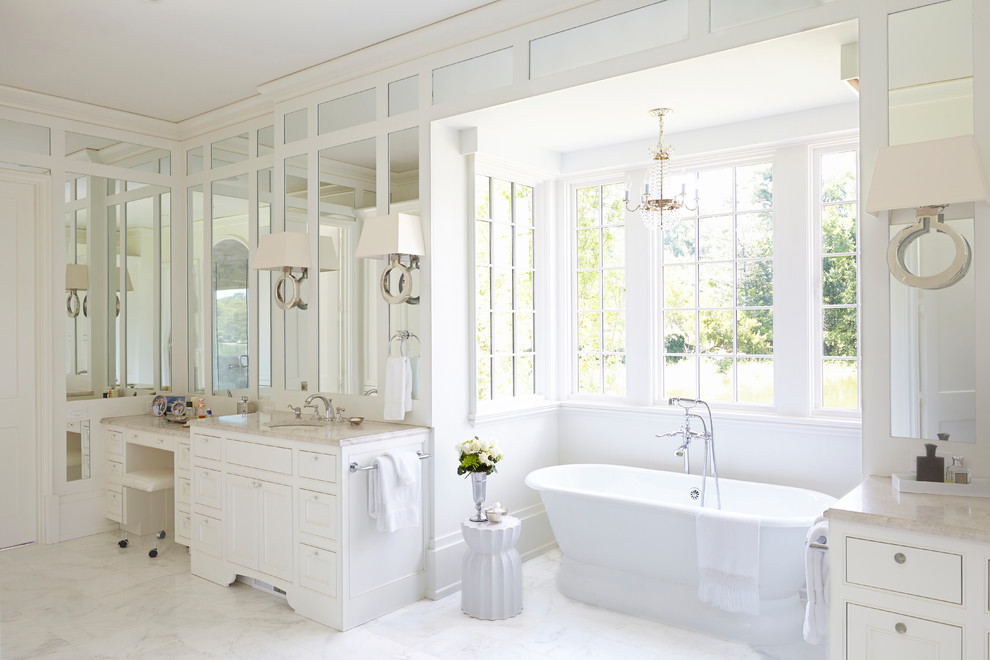 Foto på ett vintage en-suite badrum, med luckor med profilerade fronter, vita skåp, ett fristående badkar, vita väggar, ett undermonterad handfat och vitt golv