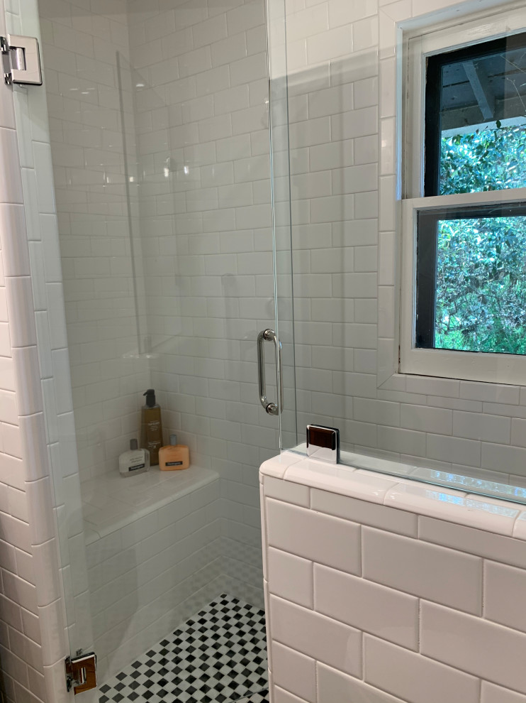 Small traditional shower room bathroom in Austin with medium wood cabinets, an alcove shower, a two-piece toilet, white tiles, metro tiles, white walls, medium hardwood flooring, a vessel sink, zinc worktops, brown floors, a hinged door, grey worktops, a shower bench, a single sink and a freestanding vanity unit.