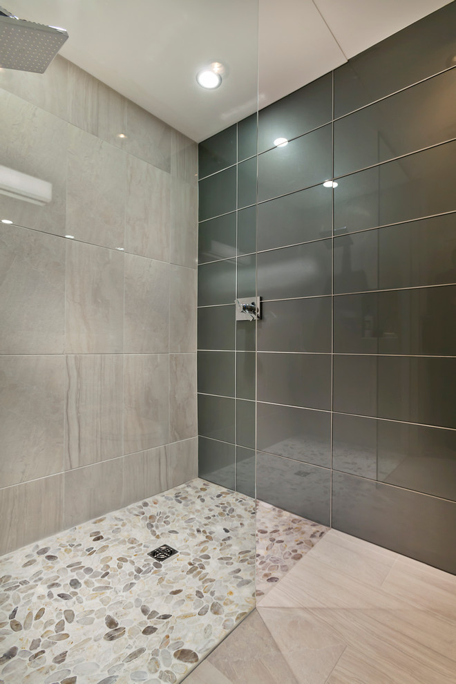 Design ideas for a small contemporary shower room bathroom in Minneapolis with a submerged sink, flat-panel cabinets, white cabinets, engineered stone worktops, a built-in shower, a one-piece toilet, grey tiles, glass tiles, multi-coloured walls and porcelain flooring.