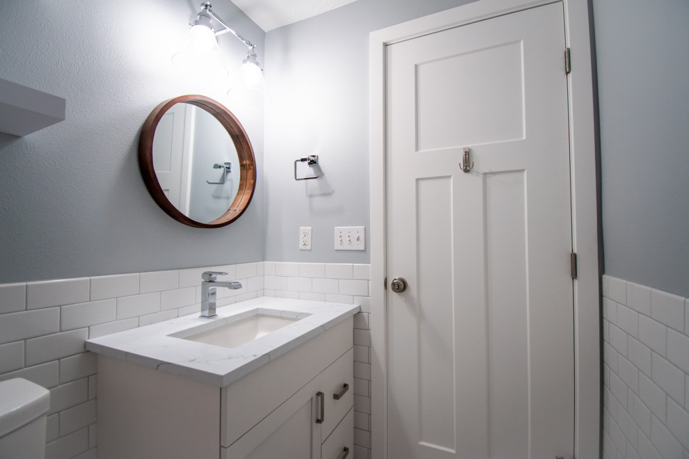 Inspiration for a small contemporary master white tile and ceramic tile medium tone wood floor and brown floor bathroom remodel in Portland with flat-panel cabinets, white cabinets, a two-piece toilet, blue walls, an undermount sink, quartzite countertops and white countertops