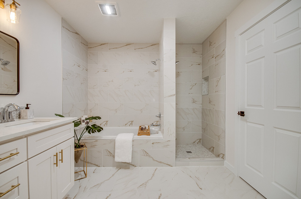 Mid-sized transitional 3/4 white tile and marble tile marble floor and white floor bathroom photo in Portland with shaker cabinets, white cabinets, a two-piece toilet, beige walls, an undermount sink, marble countertops, a hinged shower door and white countertops