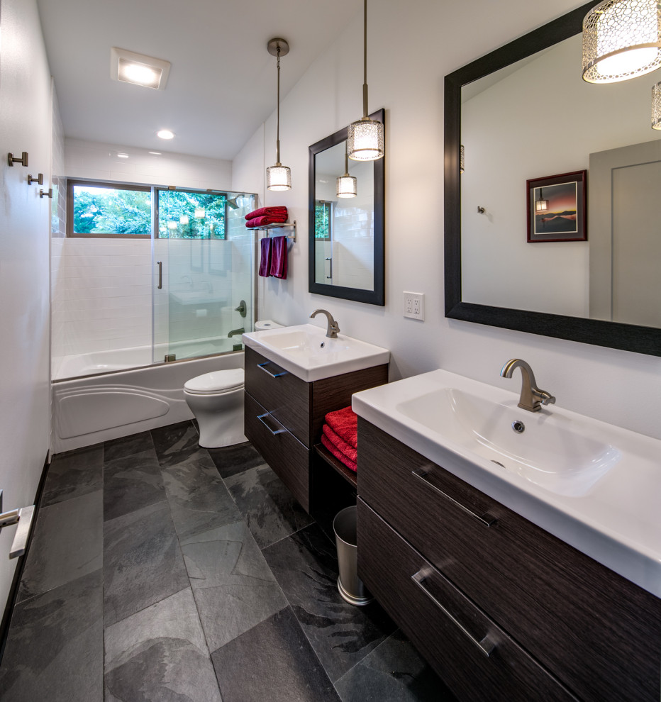 Medium sized contemporary family bathroom in Seattle with flat-panel cabinets, grey cabinets, an alcove bath, a built-in shower, a one-piece toilet, white tiles, metro tiles, grey walls, slate flooring, an integrated sink, quartz worktops, black floors, a sliding door and white worktops.