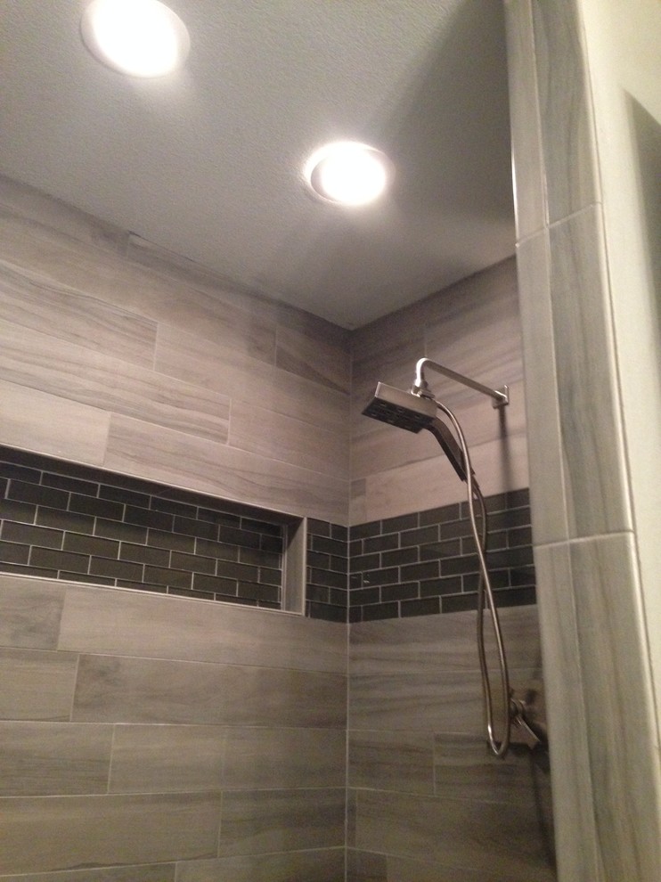 Inspiration for a mid-sized contemporary 3/4 gray tile and porcelain tile alcove shower remodel in Little Rock with gray walls