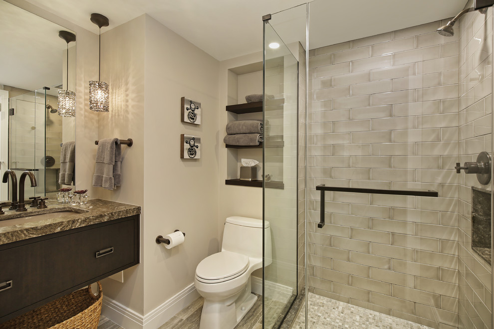 Corner shower - large transitional beige tile and ceramic tile porcelain tile corner shower idea in Chicago with flat-panel cabinets, dark wood cabinets, a one-piece toilet, beige walls, an undermount sink, granite countertops, a hinged shower door and brown countertops